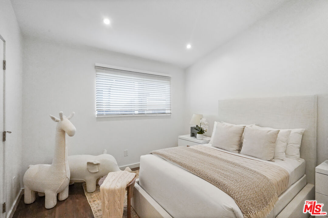 940 Rose Avenue Venice, CA 90291 - Photo 24 of 39 a bedroom with a bed and wooden floor