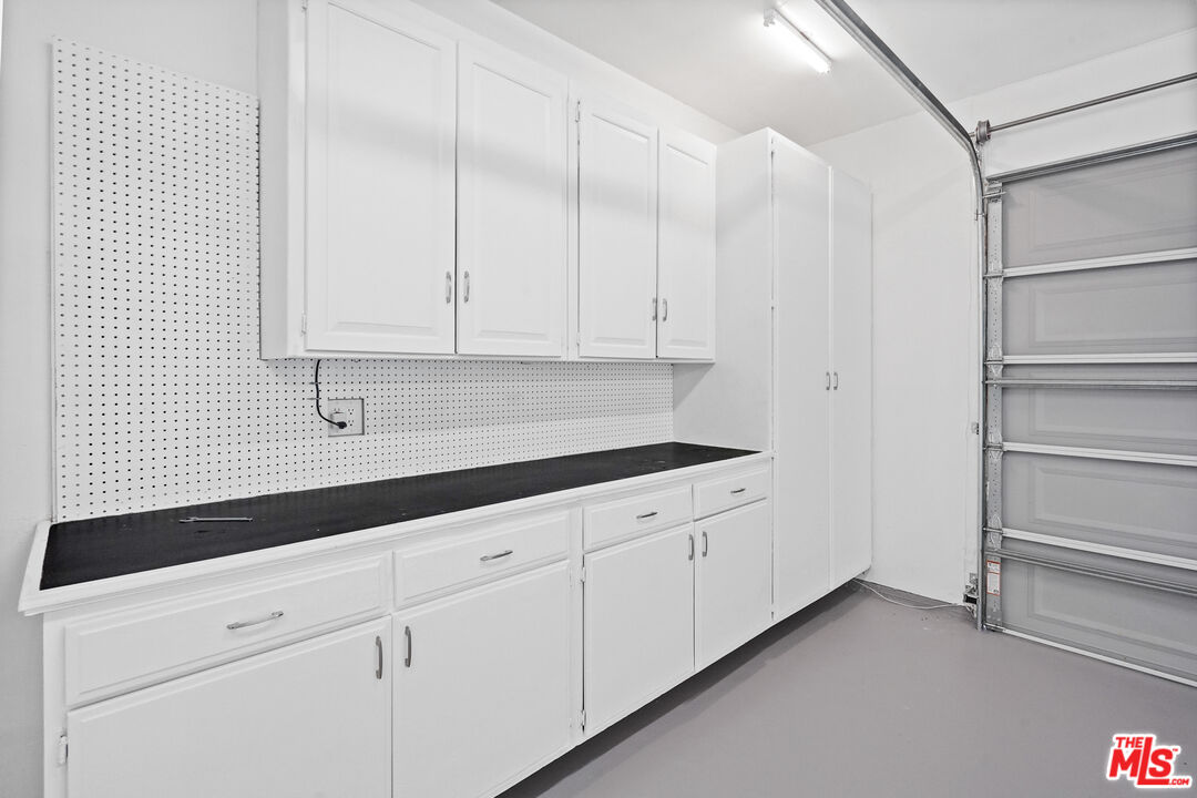 940 Rose Avenue Venice, CA 90291 - Photo 33 of 39 a kitchen with granite countertop white cabinets and white appliances