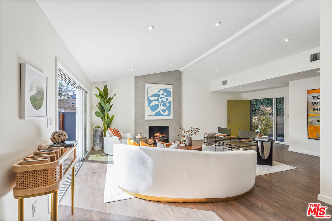 940 Rose Avenue Venice, CA 90291 - Photo 4 of 39 a living room with couches and a dining table with wooden floor