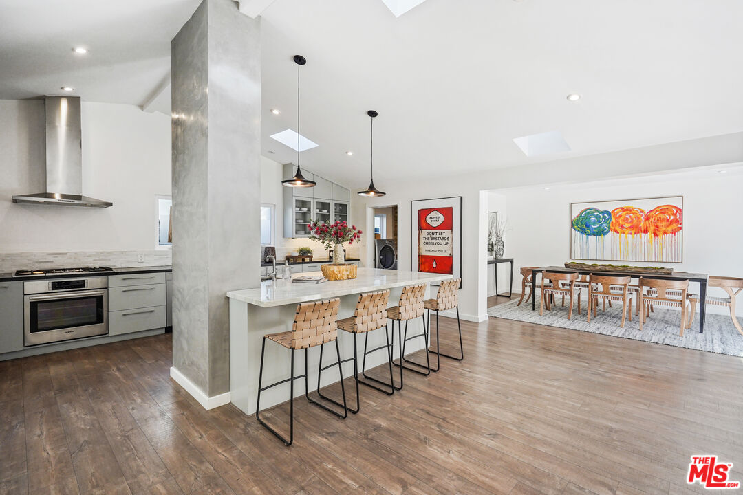 940 Rose Avenue Venice, CA 90291 - Photo 10 of 39 a kitchen with stainless steel appliances a stove a sink dishwasher and a refrigerator with wooden floor