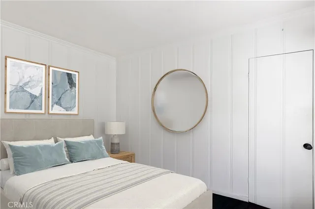 a bedroom with a large bed and a window