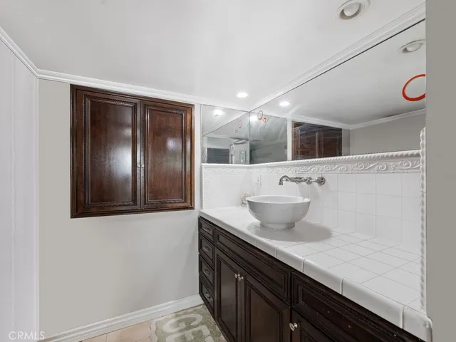 a bathroom with a sink and two mirror