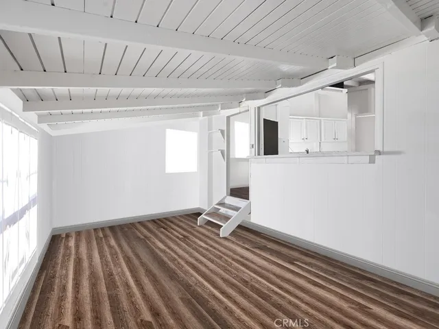 a room with wooden floor and window