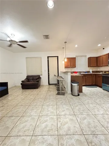 a kitchen with stainless steel appliances a sink a stove a microwave a counter top space and cabinets