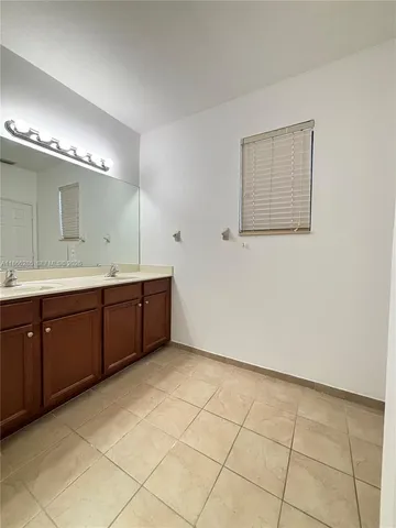 a spacious bathroom with a double vanity sink and a mirror