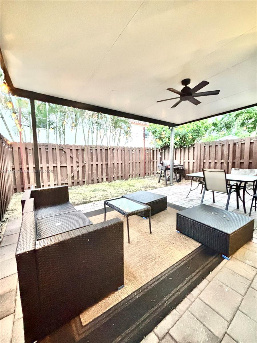 17443 Southwest 153rd Path, Unit 17443 Miami, FL 33187 - Photo 9 of 10 a living room with furniture and a large window