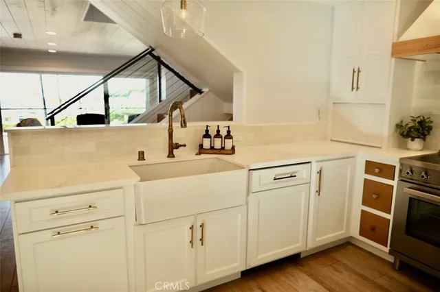 a kitchen with a sink appliances and cabinets