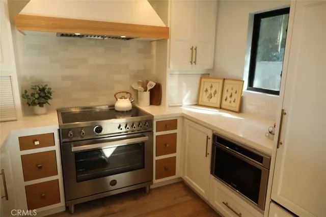 a stove top oven sitting inside of a kitchen