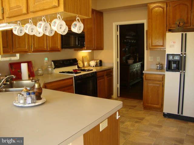 2470 Five Shillings Road Frederick, MD 21701 - Photo 4 of 17 a kitchen with a sink and refrigerator