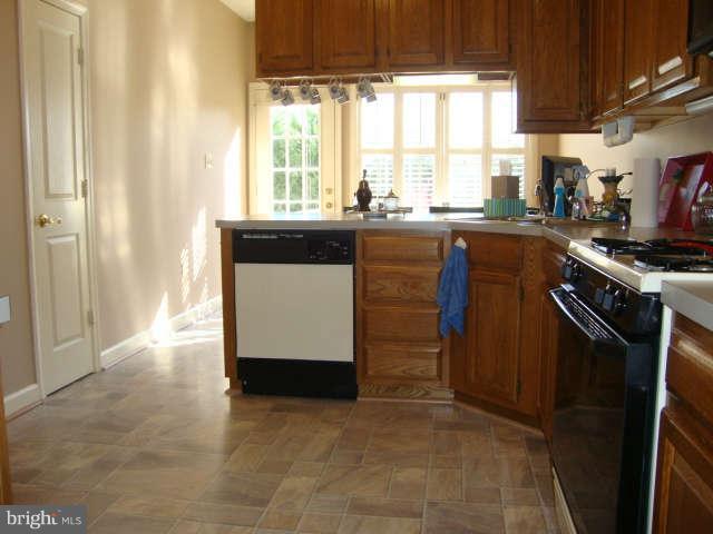 2470 Five Shillings Road Frederick, MD 21701 - Photo 5 of 17 a kitchen with stainless steel appliances granite countertop a stove a sink and a refrigerator
