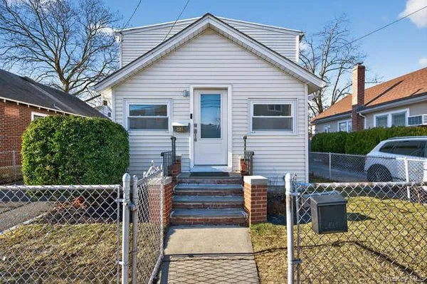 a front view of house with wooden fence