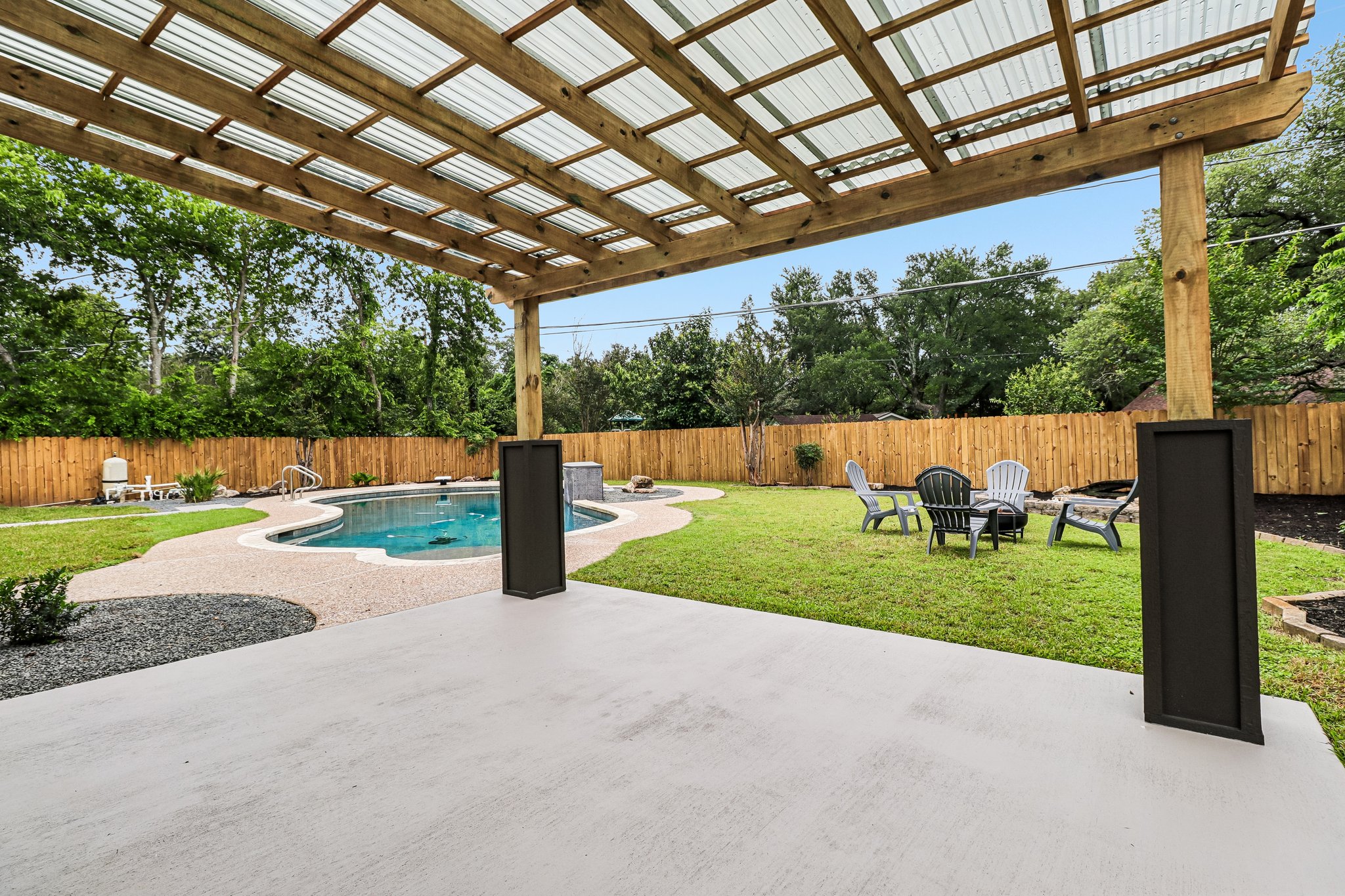 11809 Charing Cross Road Austin, TX 78759 - Photo 24 of 34 A private backyard oasis features a free-form pool, ample patio space, and a relaxing fire pit area.