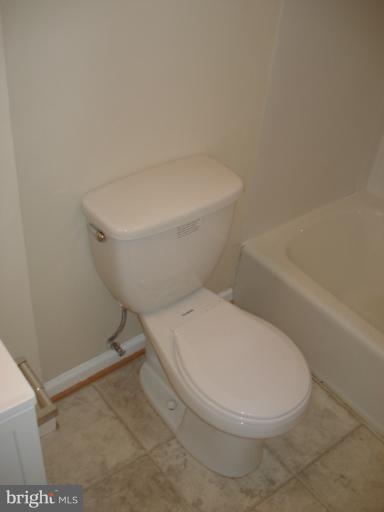 1975 Addison Road South, Unit 1975 District Heights, MD 20747 - Photo 5 of 15 a white toilet sitting next to a bath tub