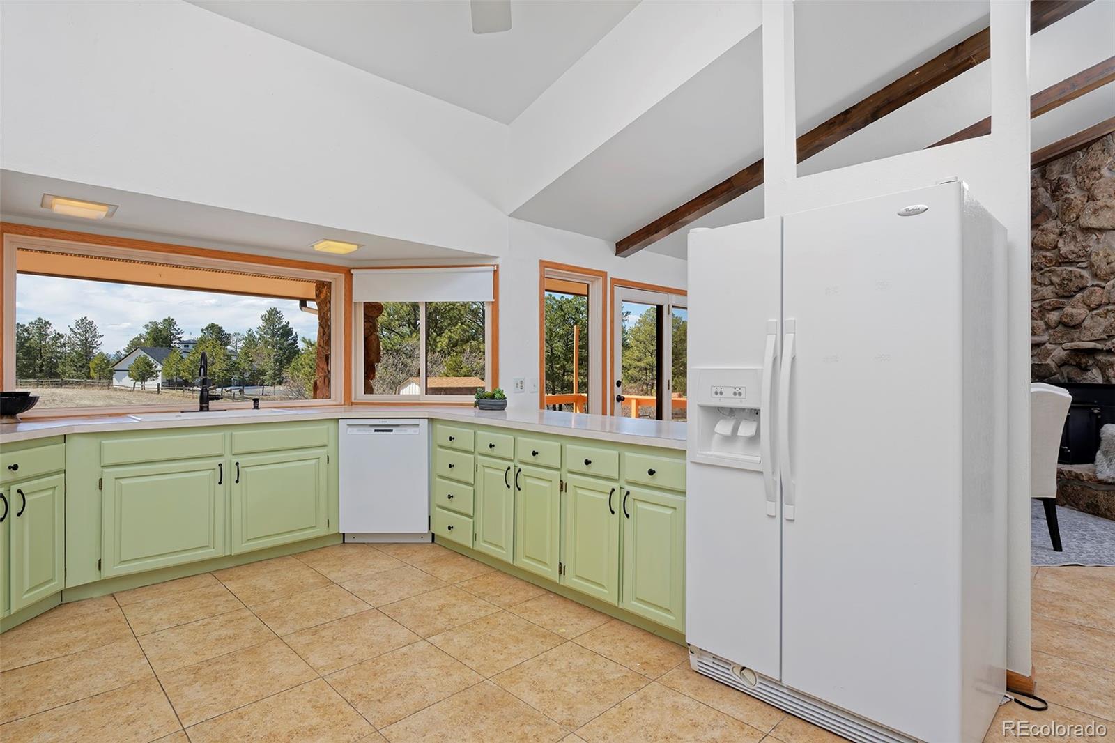 1340 Deerpath Trail Franktown, CO 80116 - Photo 12 of 44 a kitchen with a sink and large window