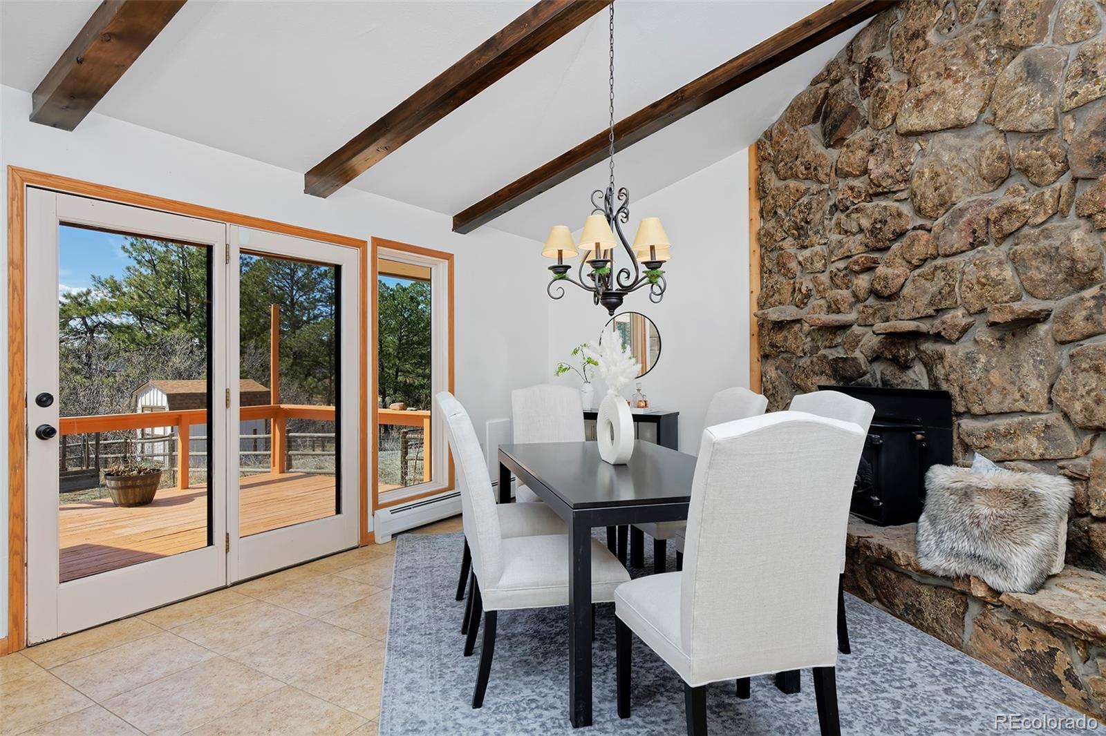 1340 Deerpath Trail Franktown, CO 80116 - Photo 16 of 44 a dining room with furniture and wooden floor