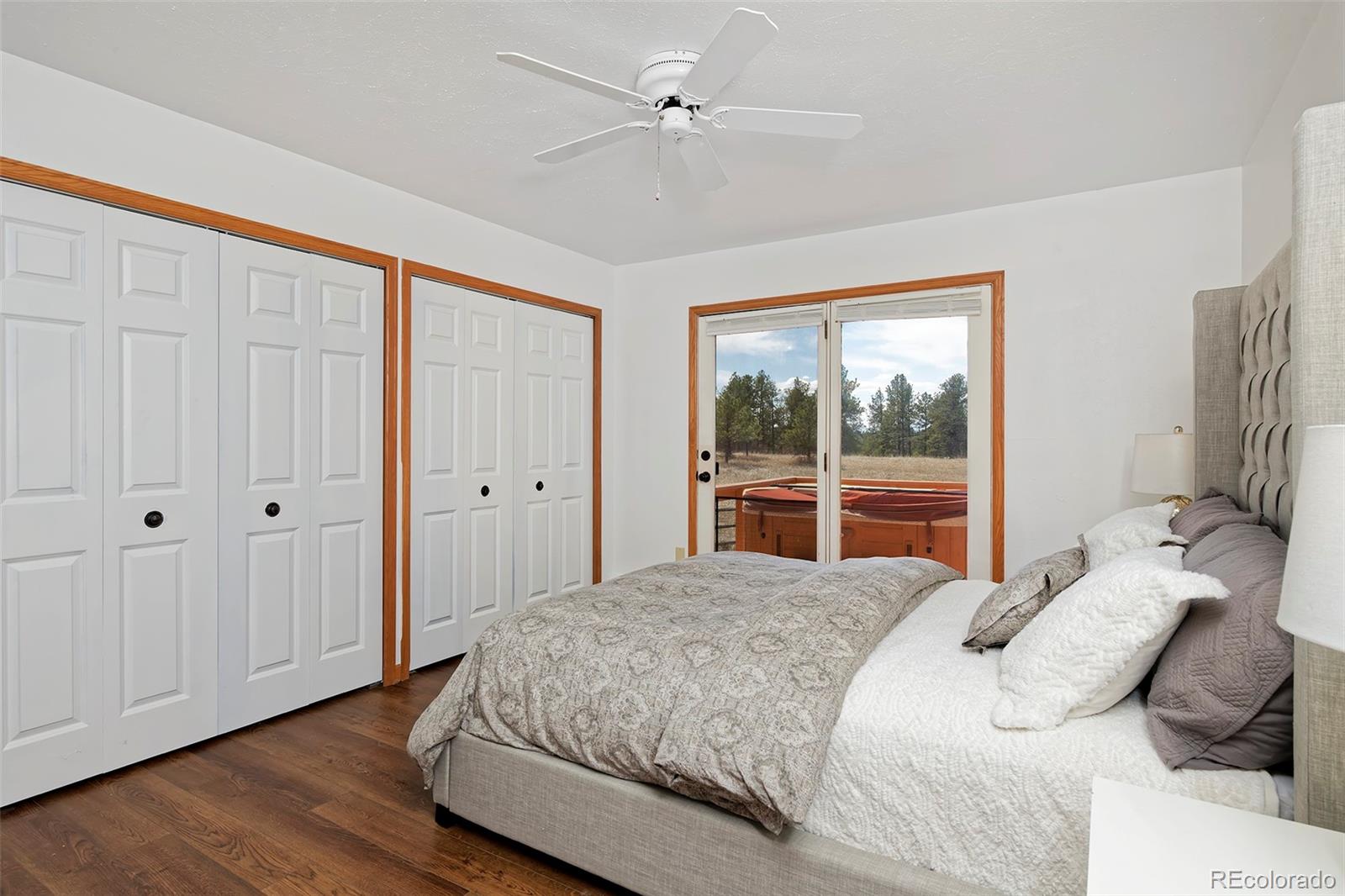 1340 Deerpath Trail Franktown, CO 80116 - Photo 19 of 44 a bedroom with a large bed and a window