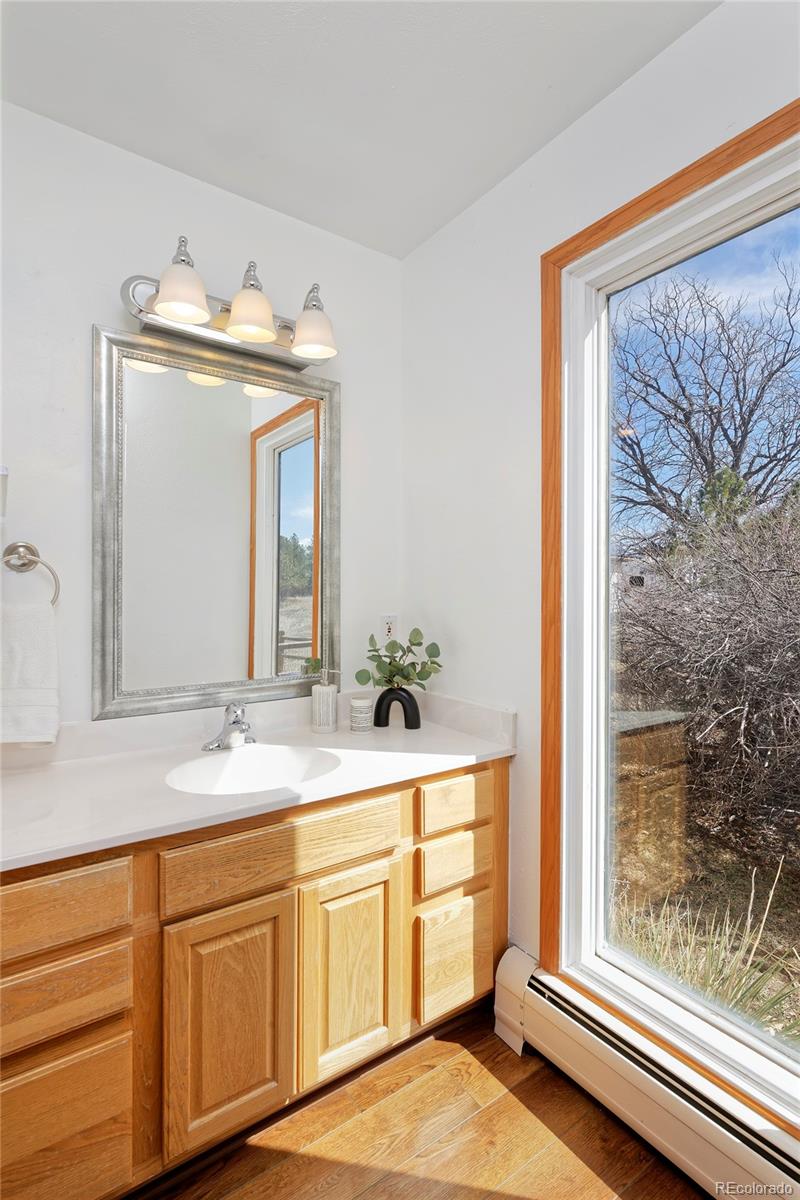1340 Deerpath Trail Franktown, CO 80116 - Photo 21 of 44 a bathroom with a granite countertop sink and a mirror