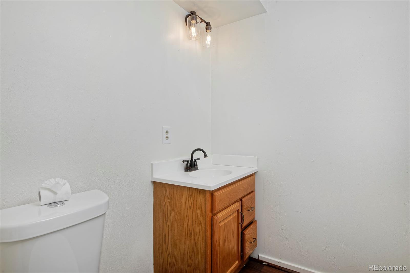 1340 Deerpath Trail Franktown, CO 80116 - Photo 30 of 44 a bathroom with a sink and a mirror