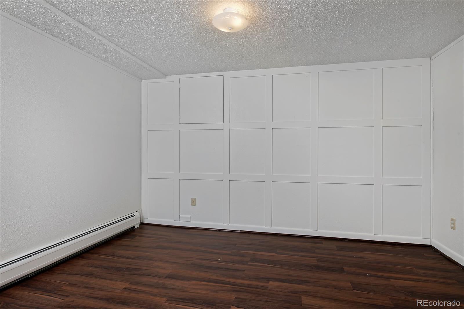 1340 Deerpath Trail Franktown, CO 80116 - Photo 32 of 44 a view of an empty room with wooden floor
