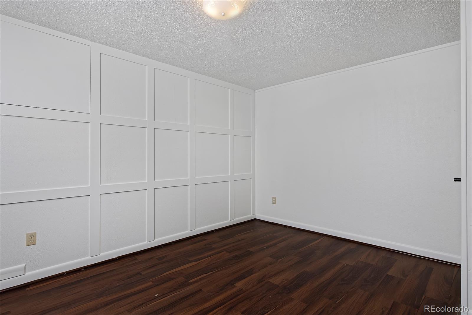1340 Deerpath Trail Franktown, CO 80116 - Photo 33 of 44 a view of a room with wooden floor