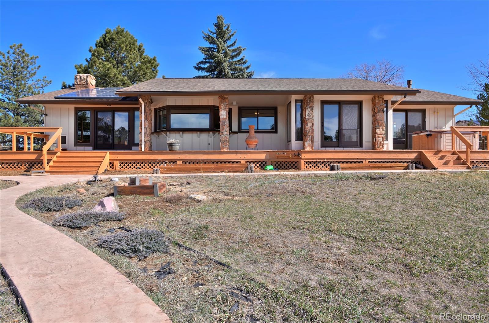 1340 Deerpath Trail Franktown, CO 80116 - Photo 40 of 44 front view of a house with a patio