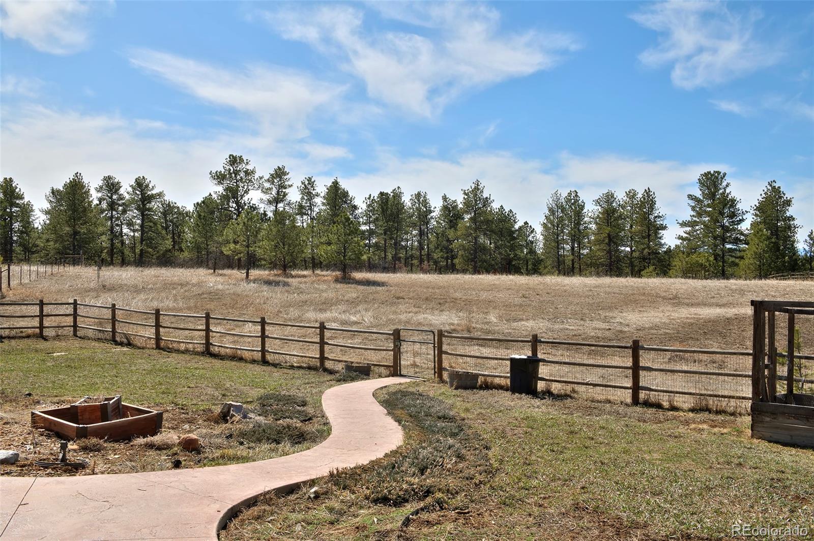 1340 Deerpath Trail Franktown, CO 80116 - Photo 43 of 44 a view of a bench in a backyard