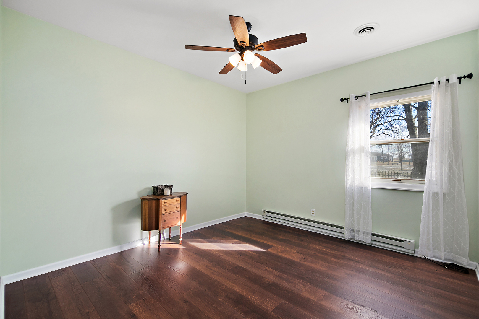 123 Crescent Lane Cabery, IL 60919 - Photo 16 of 22 an empty room with wooden floor and windows
