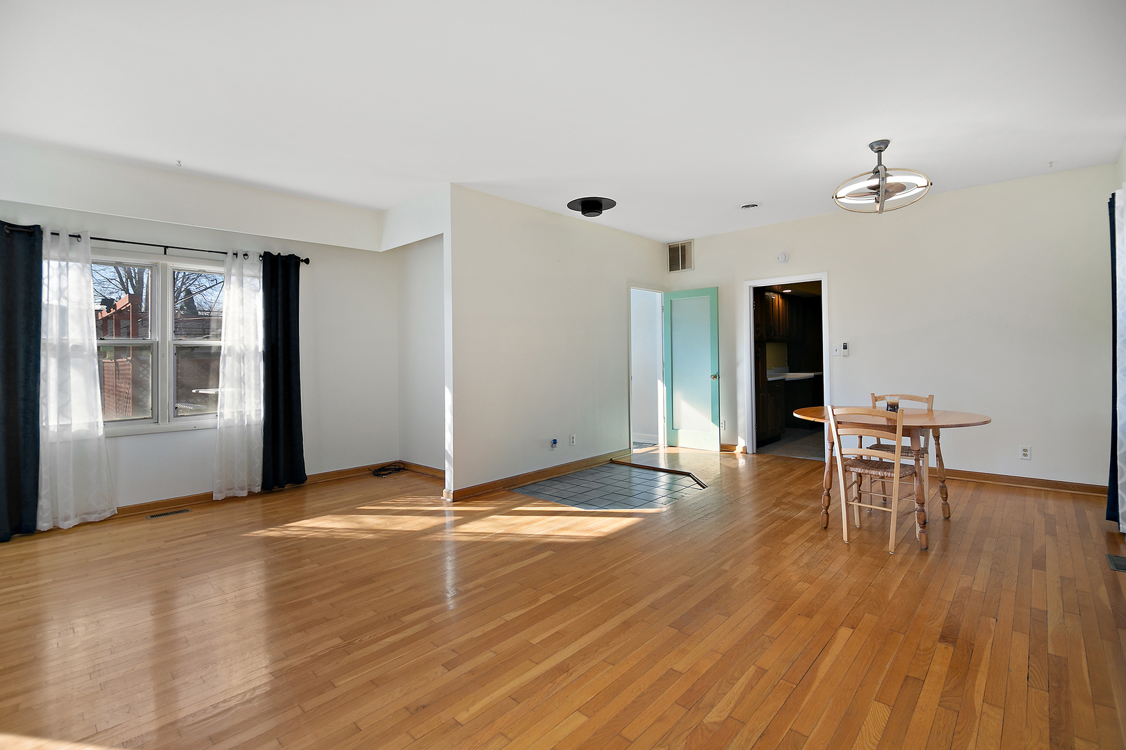 123 Crescent Lane Cabery, IL 60919 - Photo 8 of 22 a view of empty room with a window and wooden floor
