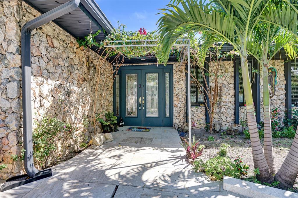 a front view of a house with a tree