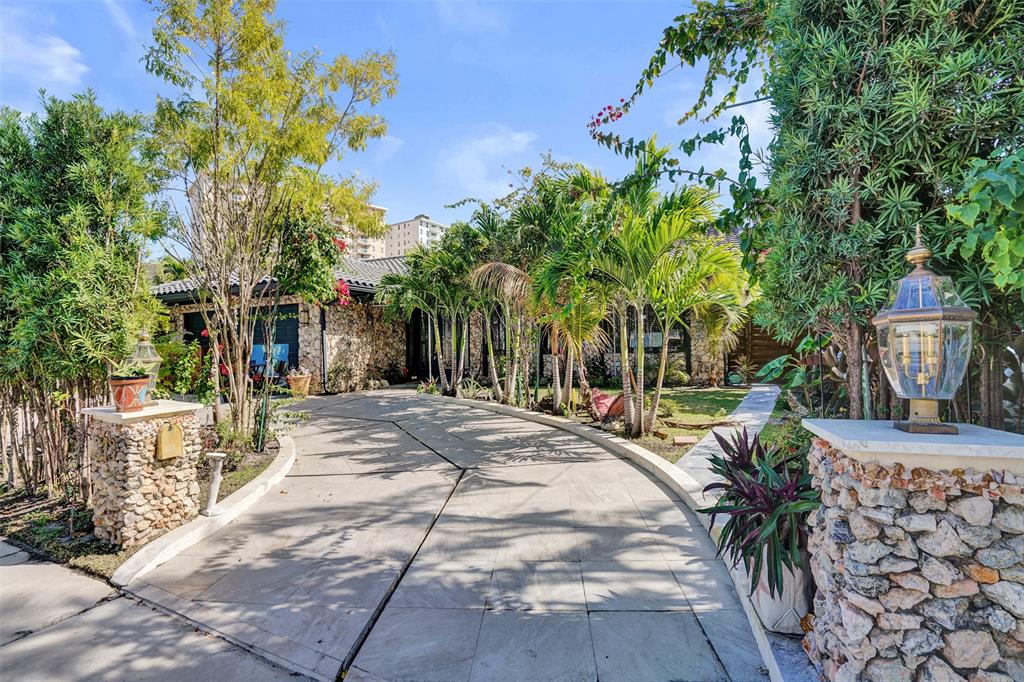 313 Layne Boulevard Hallandale Beach, FL 33009 - Photo 2 of 48 a view of a backyard with plants and trees