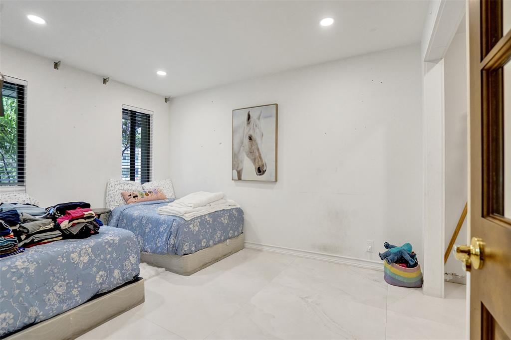 313 Layne Boulevard Hallandale Beach, FL 33009 - Photo 29 of 48 a bedroom with furniture and a mirror