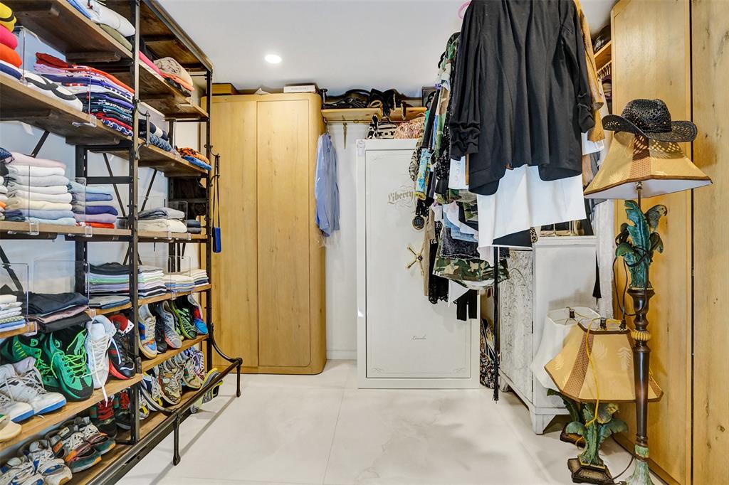 313 Layne Boulevard Hallandale Beach, FL 33009 - Photo 34 of 48 a view of walk in closet with clothes and shoes