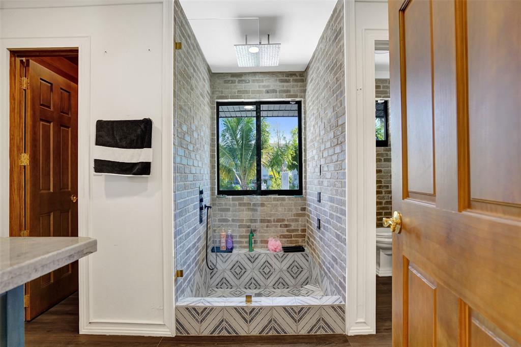 313 Layne Boulevard Hallandale Beach, FL 33009 - Photo 35 of 48 a view of a hallway with wooden floor and windows