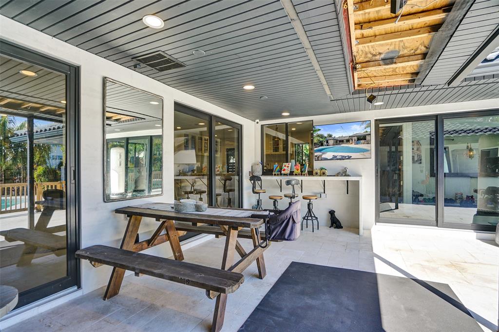 313 Layne Boulevard Hallandale Beach, FL 33009 - Photo 40 of 48 a view of a patio with table and chairs