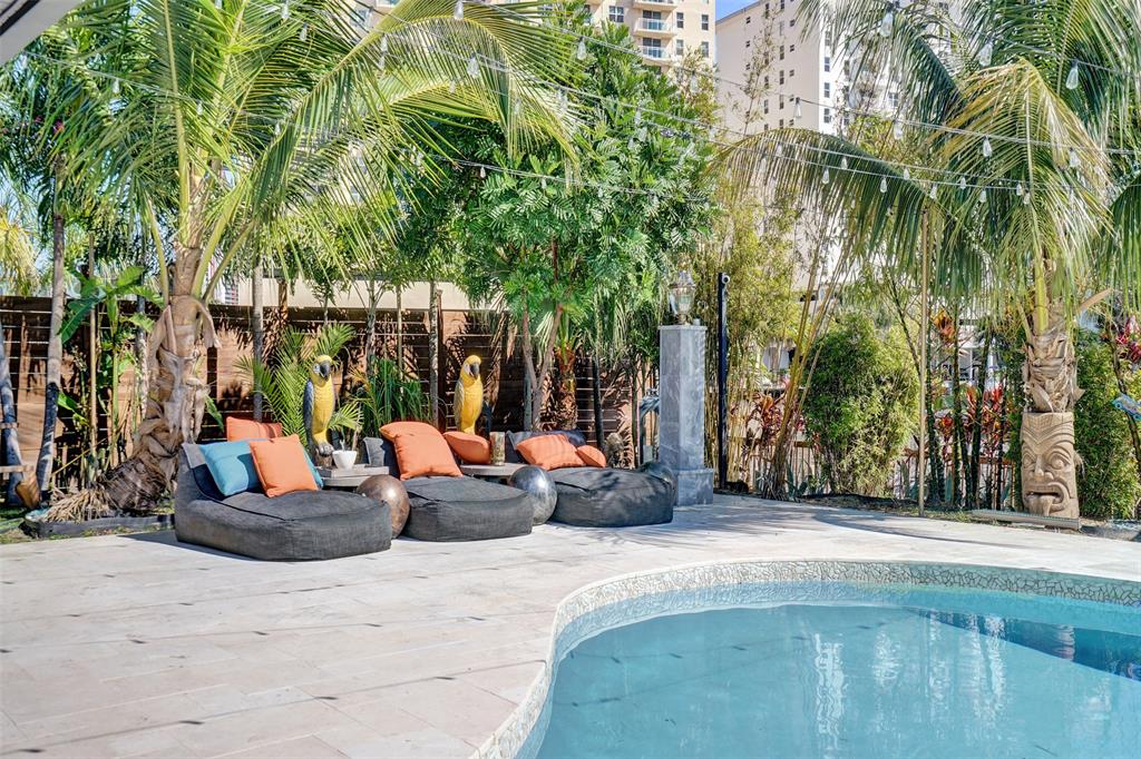 313 Layne Boulevard Hallandale Beach, FL 33009 - Photo 43 of 48 a view of a patio with couches and potted plants