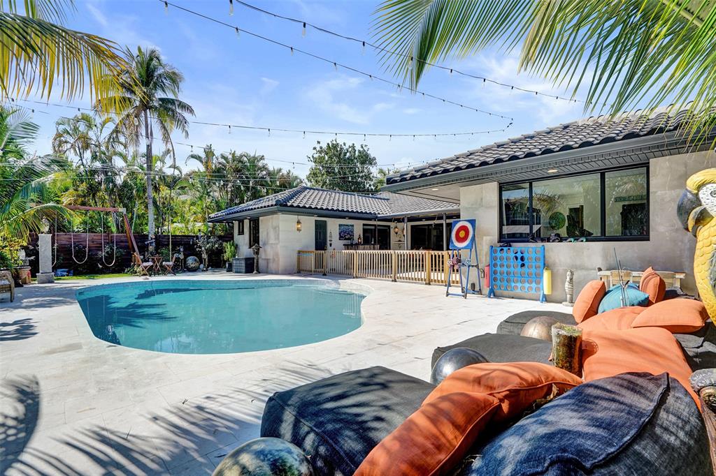 313 Layne Boulevard Hallandale Beach, FL 33009 - Photo 45 of 48 a view of a house with swimming pool and sitting area