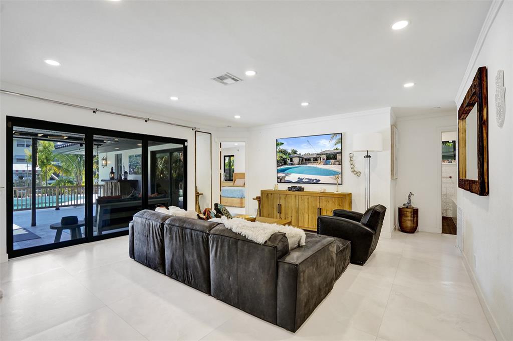 313 Layne Boulevard Hallandale Beach, FL 33009 - Photo 5 of 48 a living room with furniture large window and flat screen tv