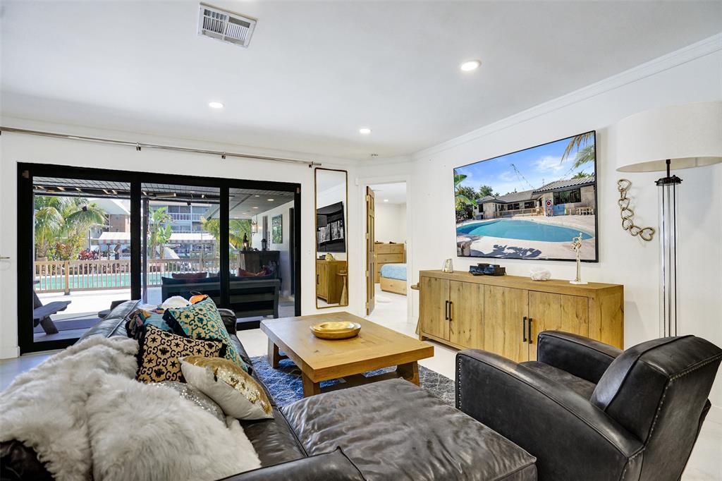 313 Layne Boulevard Hallandale Beach, FL 33009 - Photo 6 of 48 a living room with furniture flat screen tv and a large window