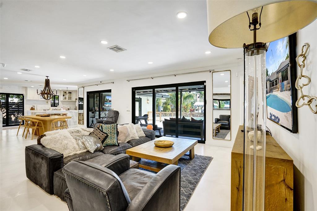 313 Layne Boulevard Hallandale Beach, FL 33009 - Photo 7 of 48 a living room with furniture fireplace and a large window