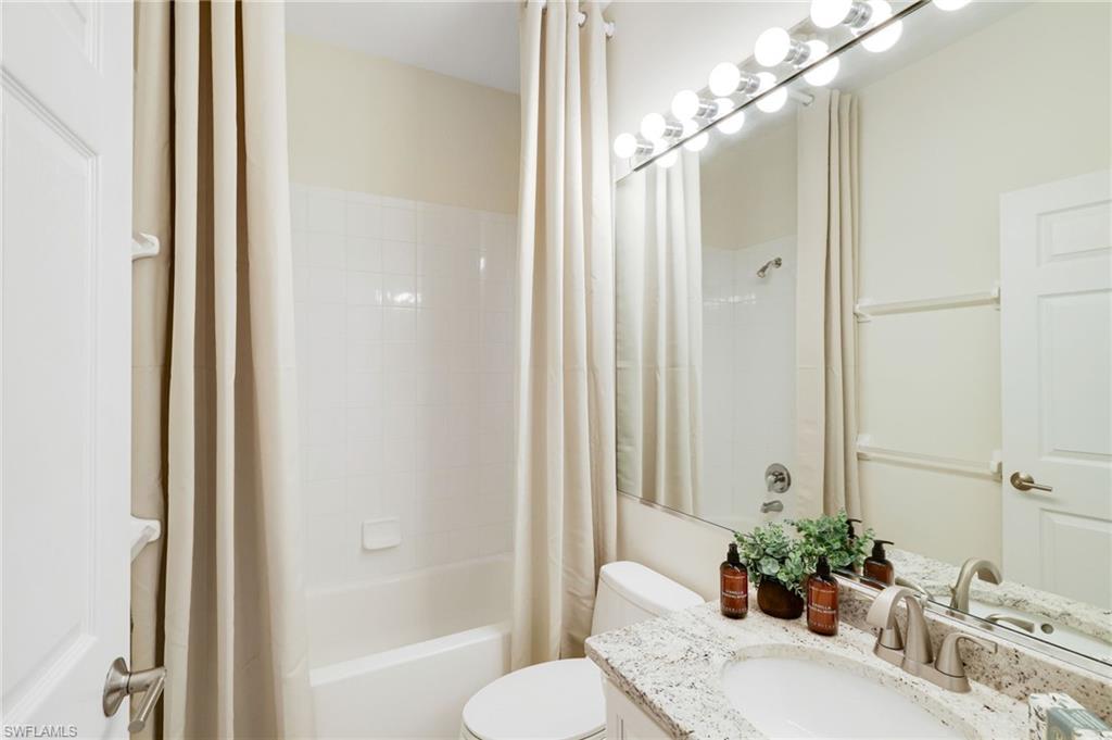17897 Modena Road Miromar Lakes, FL 33913 - Photo 15 of 40 a bathroom with a granite countertop sink toilet and shower