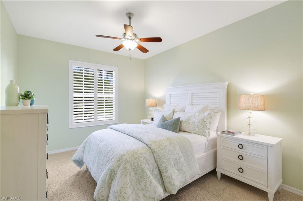 17897 Modena Road Miromar Lakes, FL 33913 - Photo 16 of 40 a bedroom with a bed and a chandelier