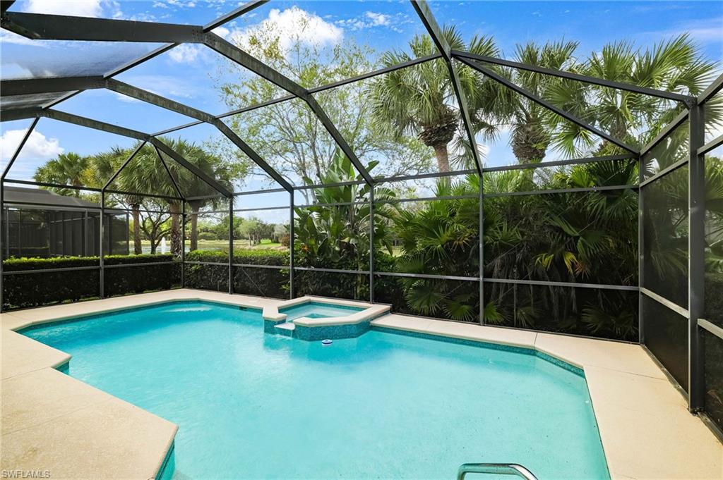 17897 Modena Road Miromar Lakes, FL 33913 - Photo 20 of 40 a view of a swimming pool with a patio and a yard