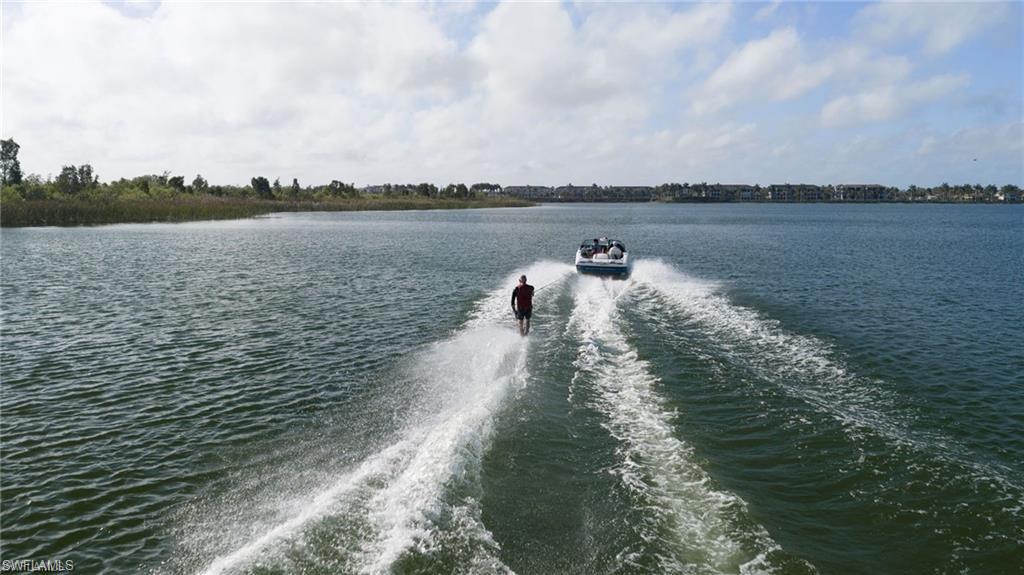 17897 Modena Road Miromar Lakes, FL 33913 - Photo 26 of 40 a view of a lake with houses in back