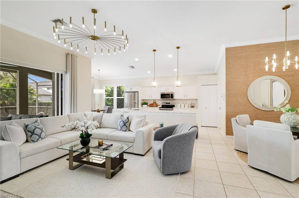 17897 Modena Road Miromar Lakes, FL 33913 - Photo 3 of 40 a living room with furniture a dining table and a chandelier