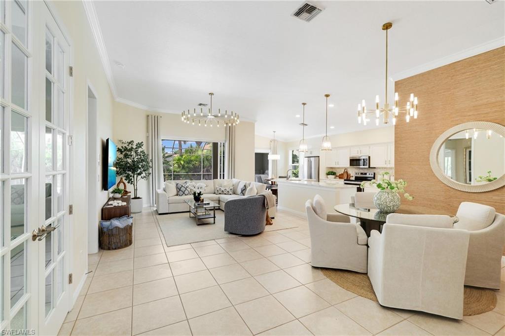 17897 Modena Road Miromar Lakes, FL 33913 - Photo 4 of 40 a living room with fireplace furniture and a chandelier