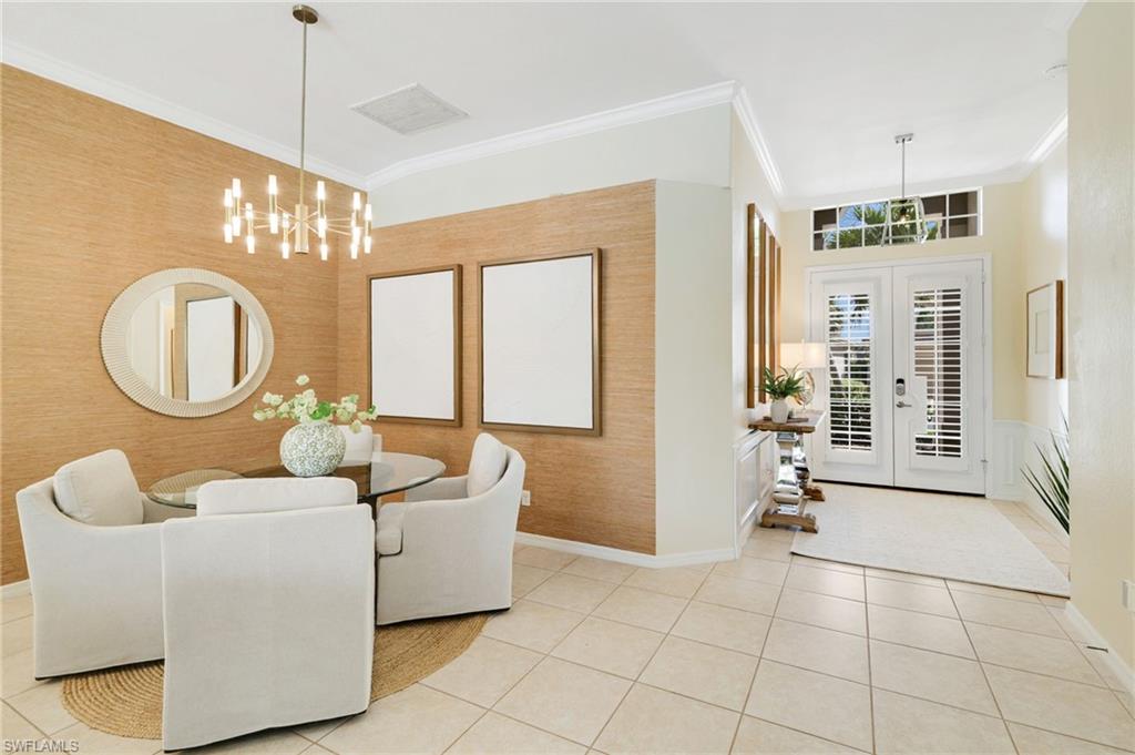 17897 Modena Road Miromar Lakes, FL 33913 - Photo 5 of 40 a living room with couches a mirror and a large window with garden view
