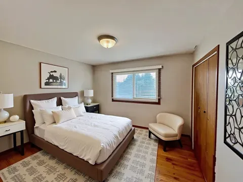 a bedroom with a bed and a painting on the wall