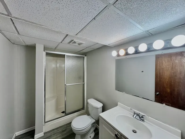 a bathroom with a toilet a sink and mirror
