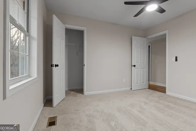 a bathroom with a sink a mirror a toilet and shower