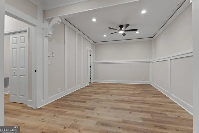 a view of empty room with wooden floor